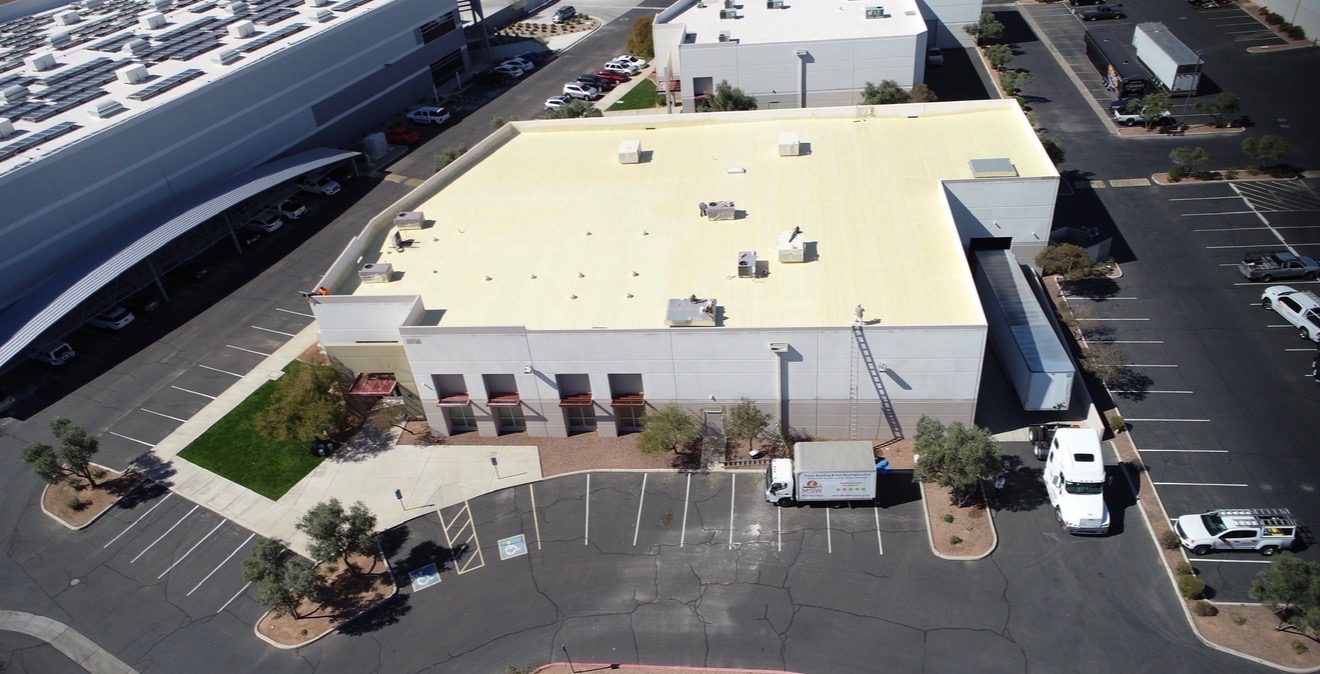 MSW Contracting Vanguard Roofing AZ crew on site at AV Dimensions Chandler during foam roof preparation with equipment ladder and MSW box truck staged for the recoat project