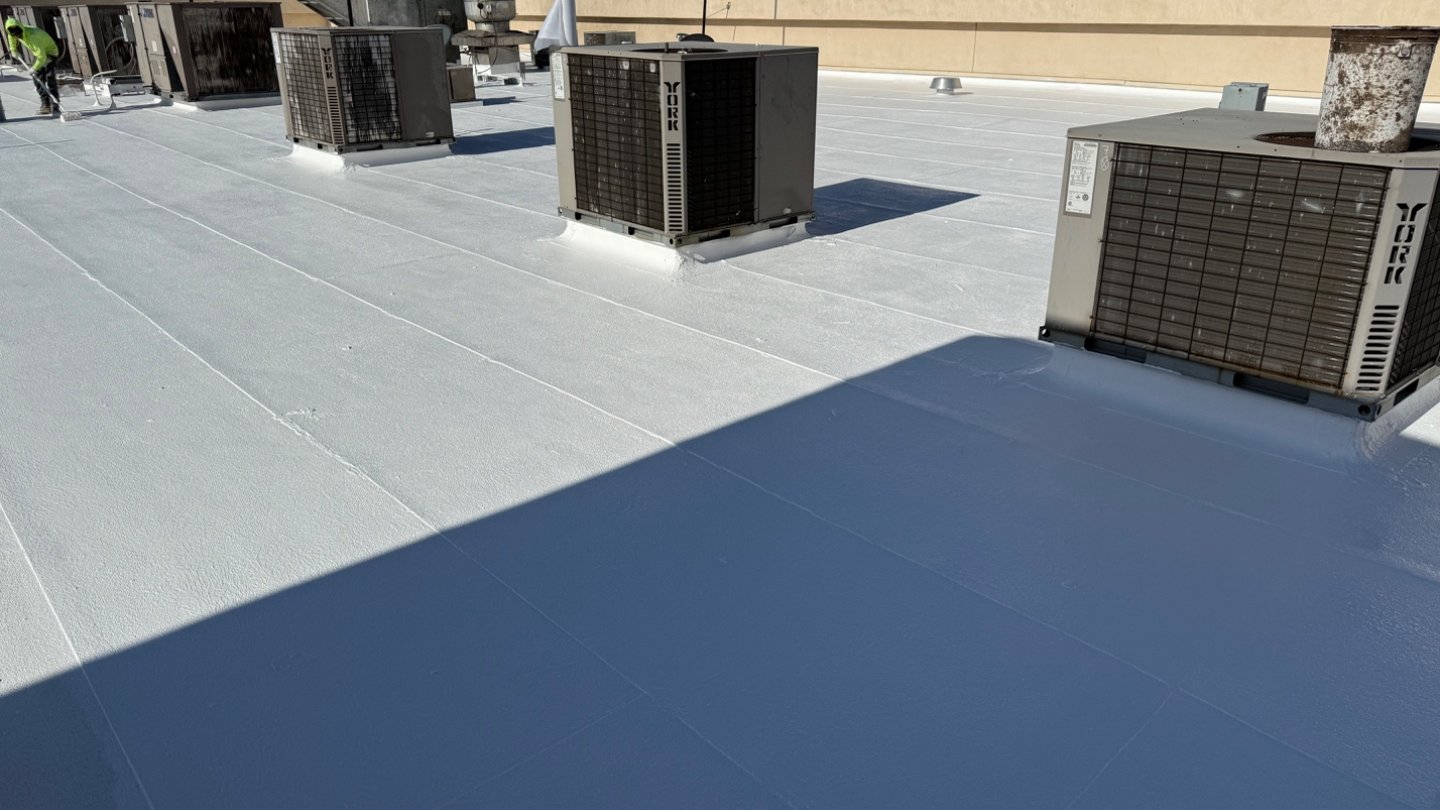Freshly-finished bright white TRC silicone roof coating on Cold Beers & Cheeseburgers Scottsdale, York HVAC condensers on foam substrate with McDowell Mountains visible in the background