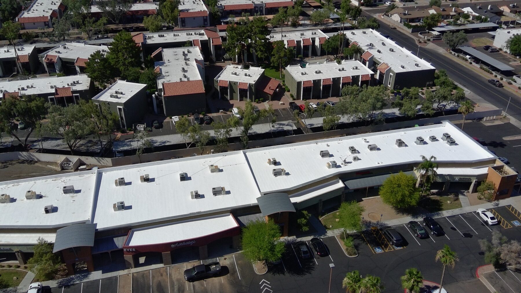 Aerial view of the Glendale retail shopping center at 51st Avenue and Thunderbird after Vanguard Roofing AZ completed the foam roof restoration