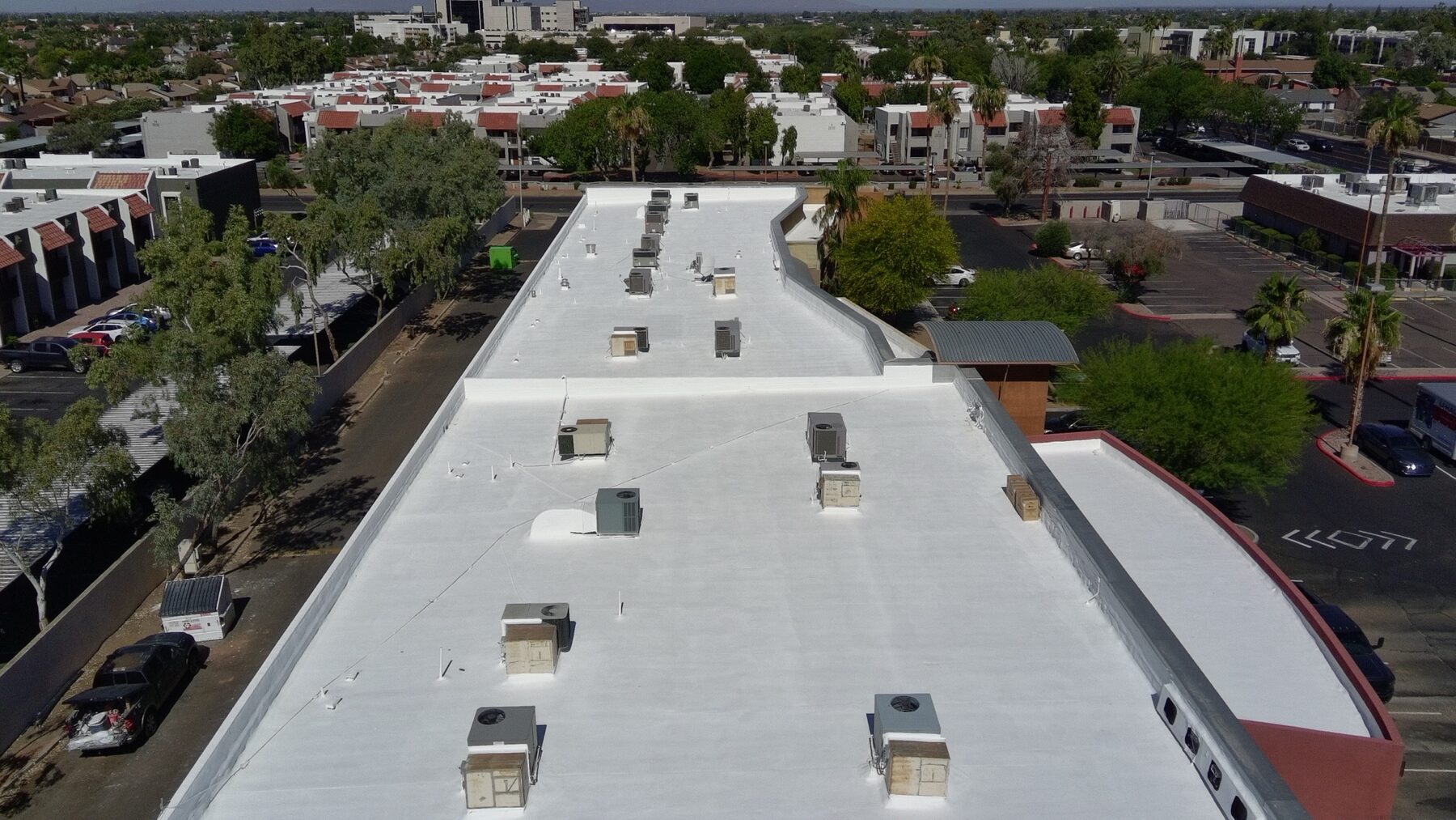 Aerial view of completed 38,000 sq ft strip mall foam roof restoration in Glendale Arizona