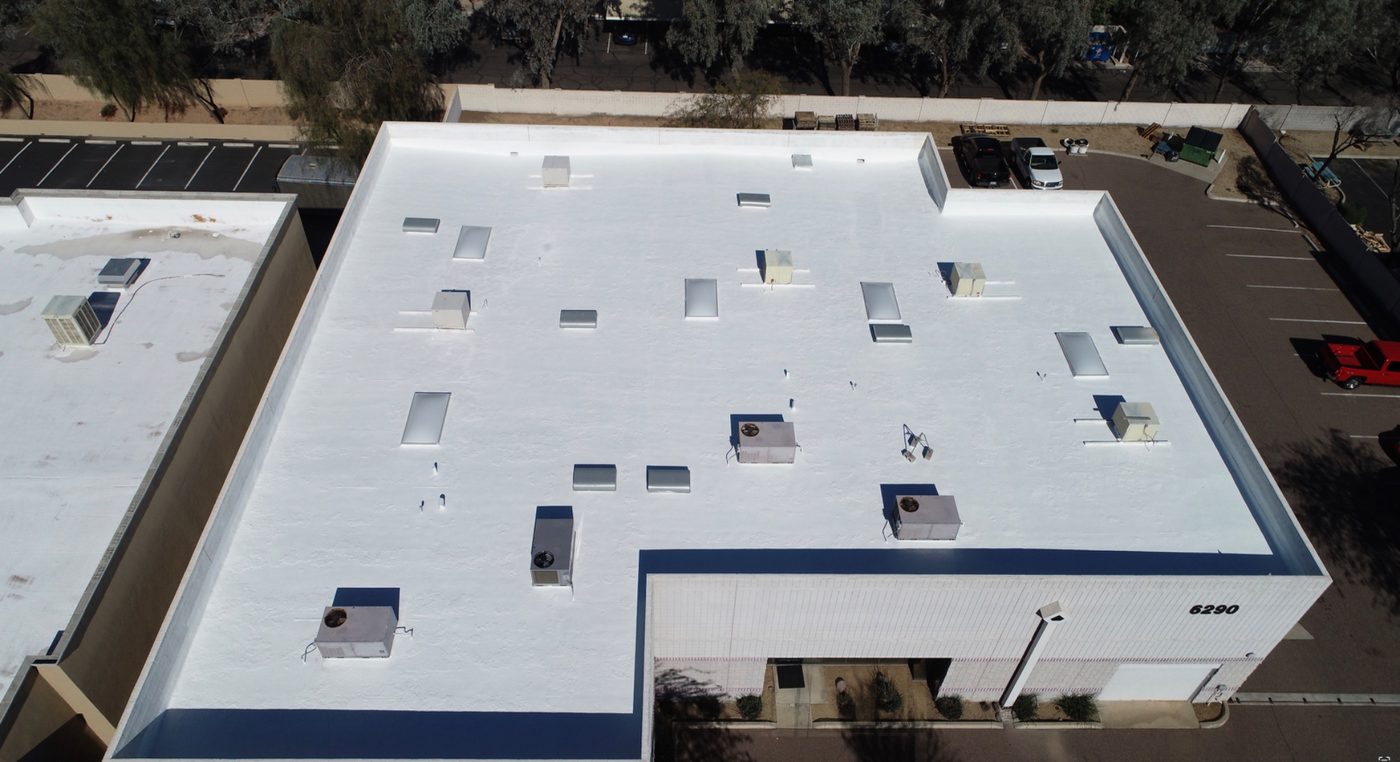 After restoration: alternate aerial angle of the completed 9,000 sq ft Chandler industrial foam roof recoat showing the bright reflective white AC100 elastomeric coating, sealed HVAC curbs, skylights, and clean parapet transitions