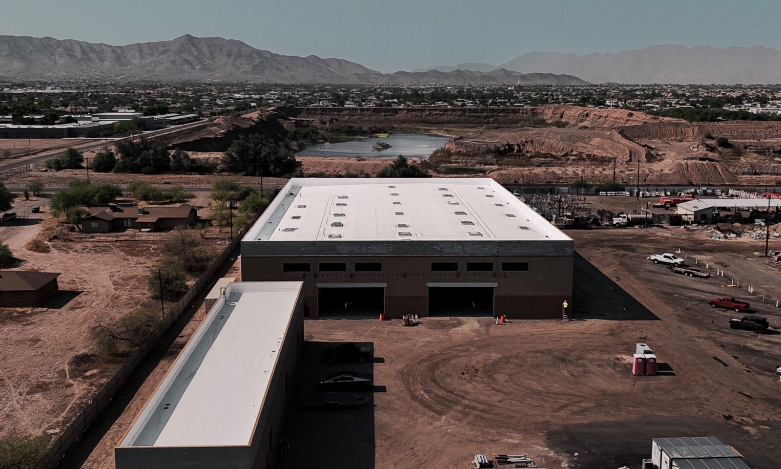 Completed 60-mil Versico fully adhered TPO roof on 38,000 sq ft industrial facility at 4002 W Wier Ave, South Phoenix, with South Mountain skyline